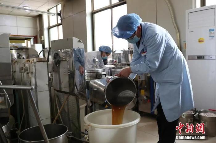 2月24日，在位于银川的宁夏中医医院暨中医院研究院中药房内，工作人员正在煎制中药汤剂。中新社记者 于晶 摄